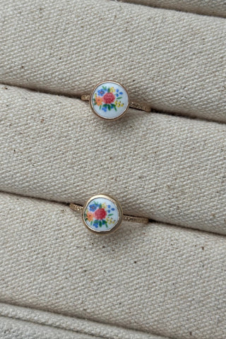 vintage floral design ring on a textured beige surface