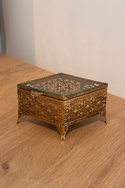 Decorative gold box on a wooden surface