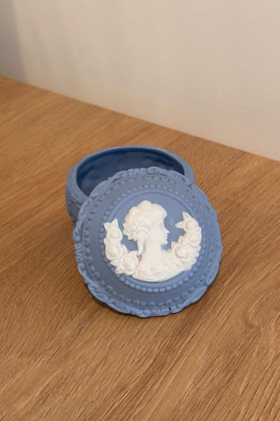 Blue decorative box with intricate design on a wooden surface