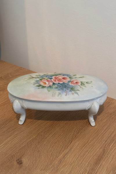 Decorative ceramic bowl with floral design on a wooden surface